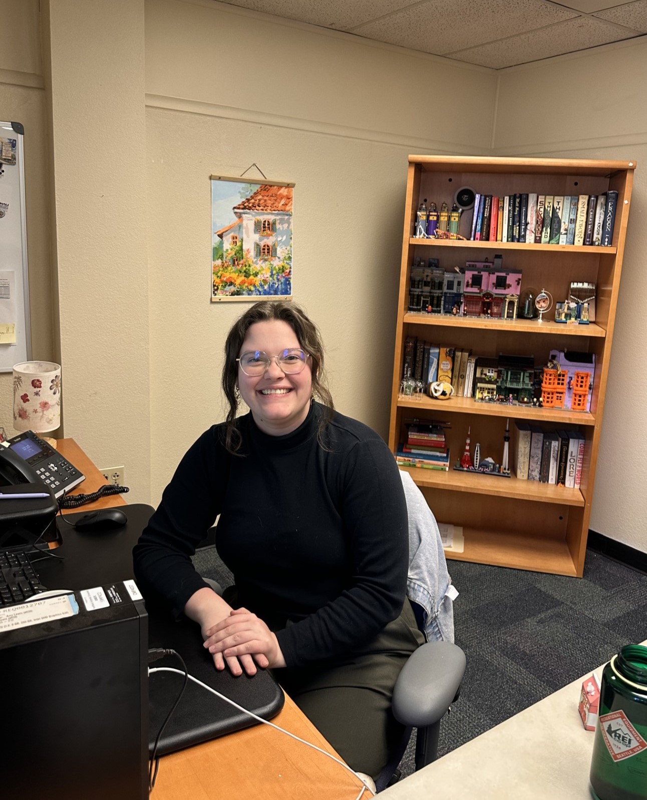 Hannah Riddell is sitting in her office and smiling.