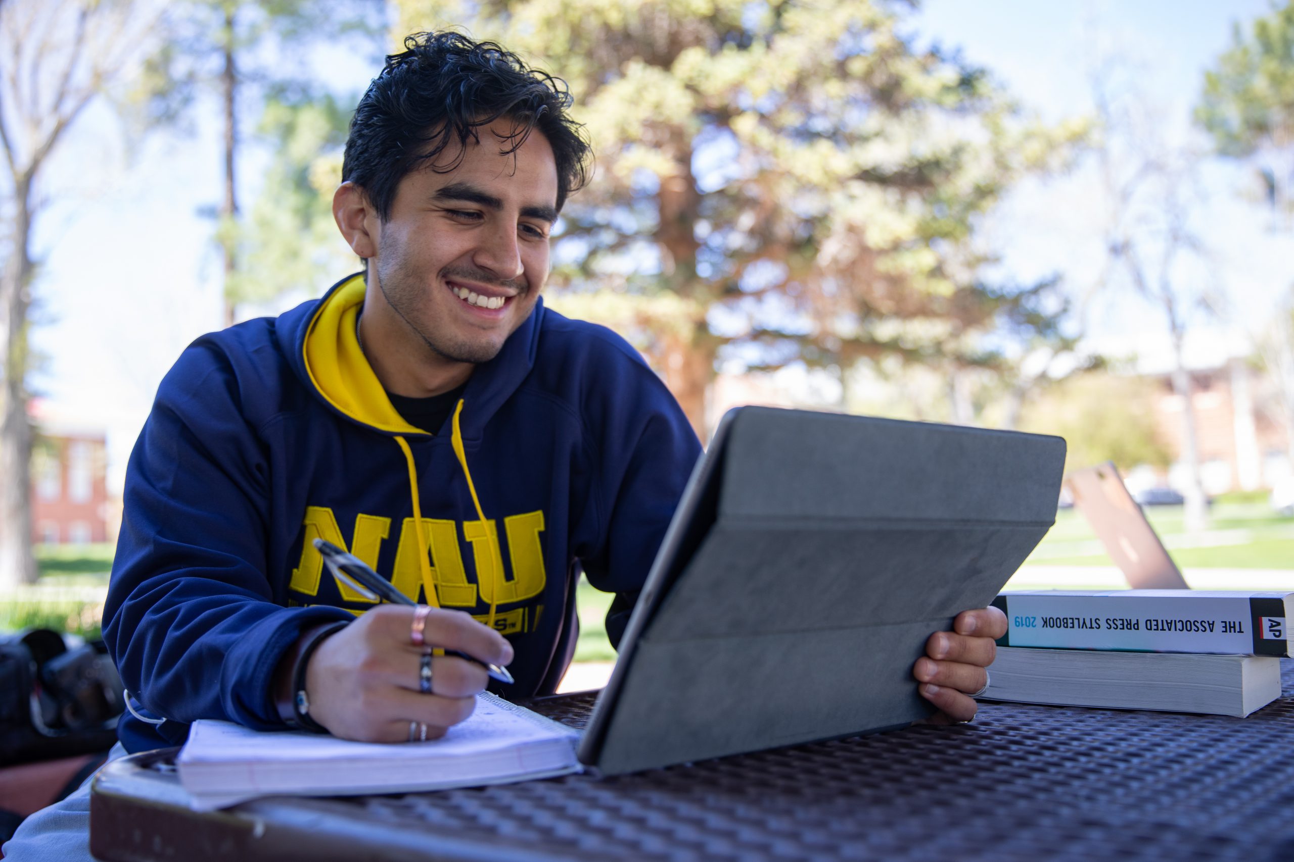 Student smiling while doing homework.