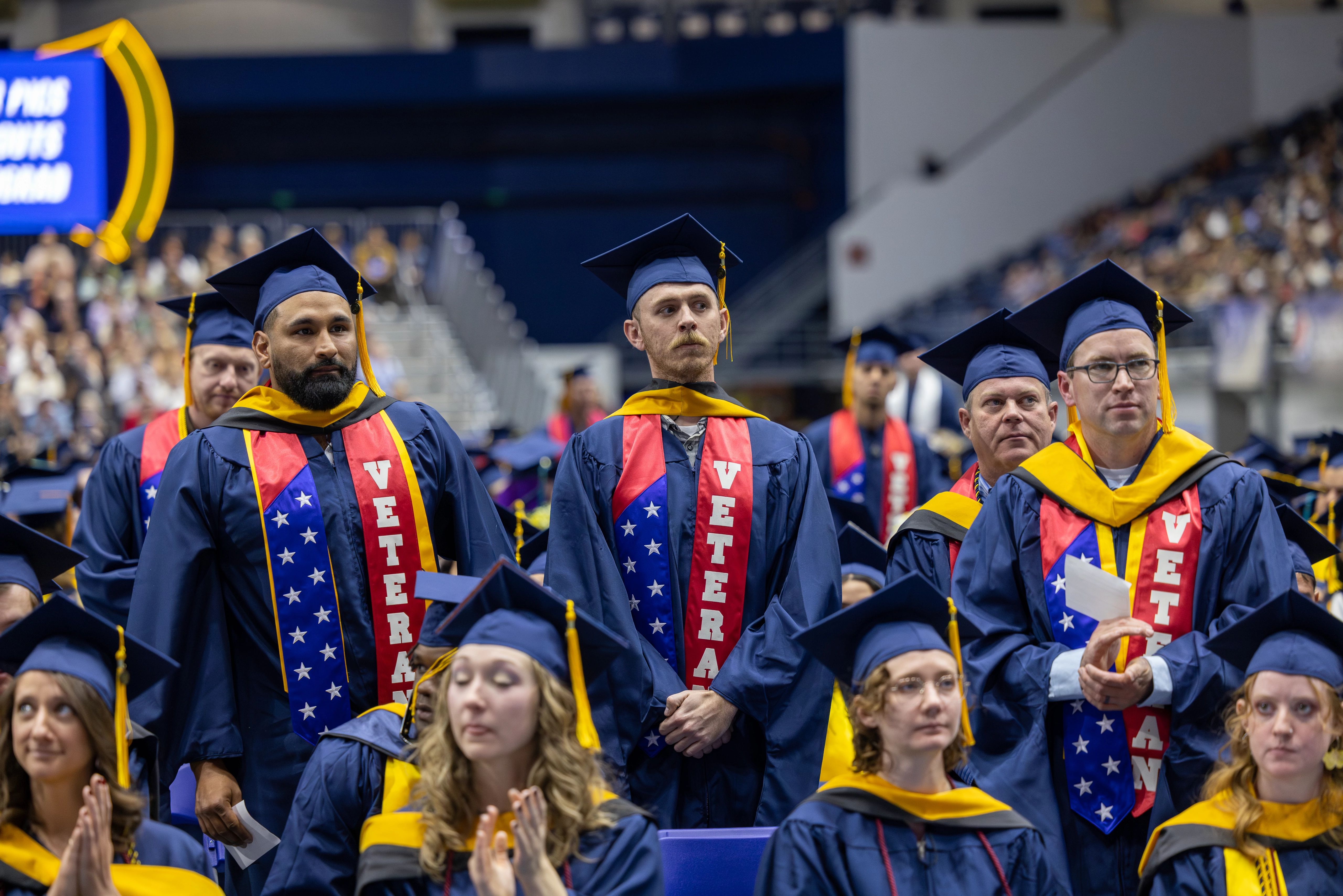 NAU military veteran students stand to be recognized during commencement