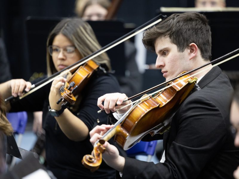 NAU student violin players in the orchestra