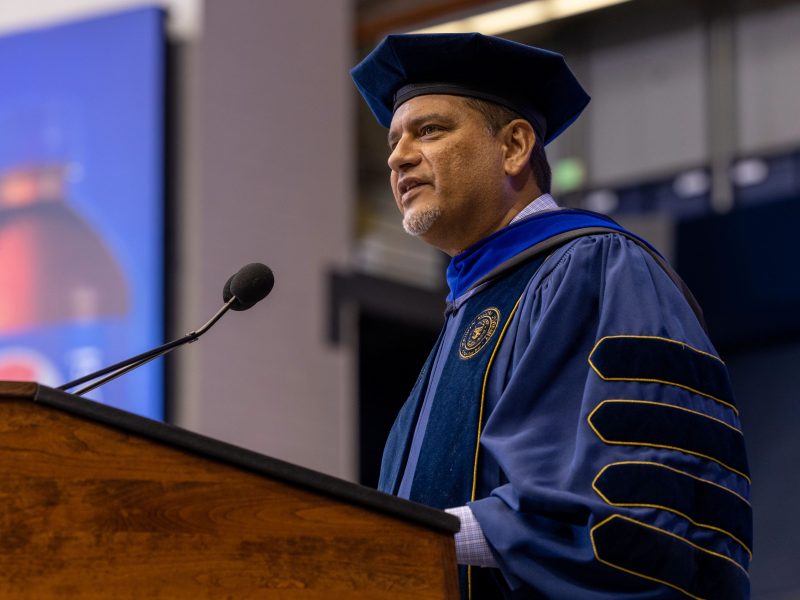 President Cruz wearing regalia and delivering a speech during NAU Commencement