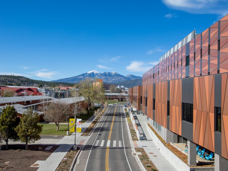 A birds-eye view of N A U's Flagstaff campus with the San Francisco peaks in the distance.