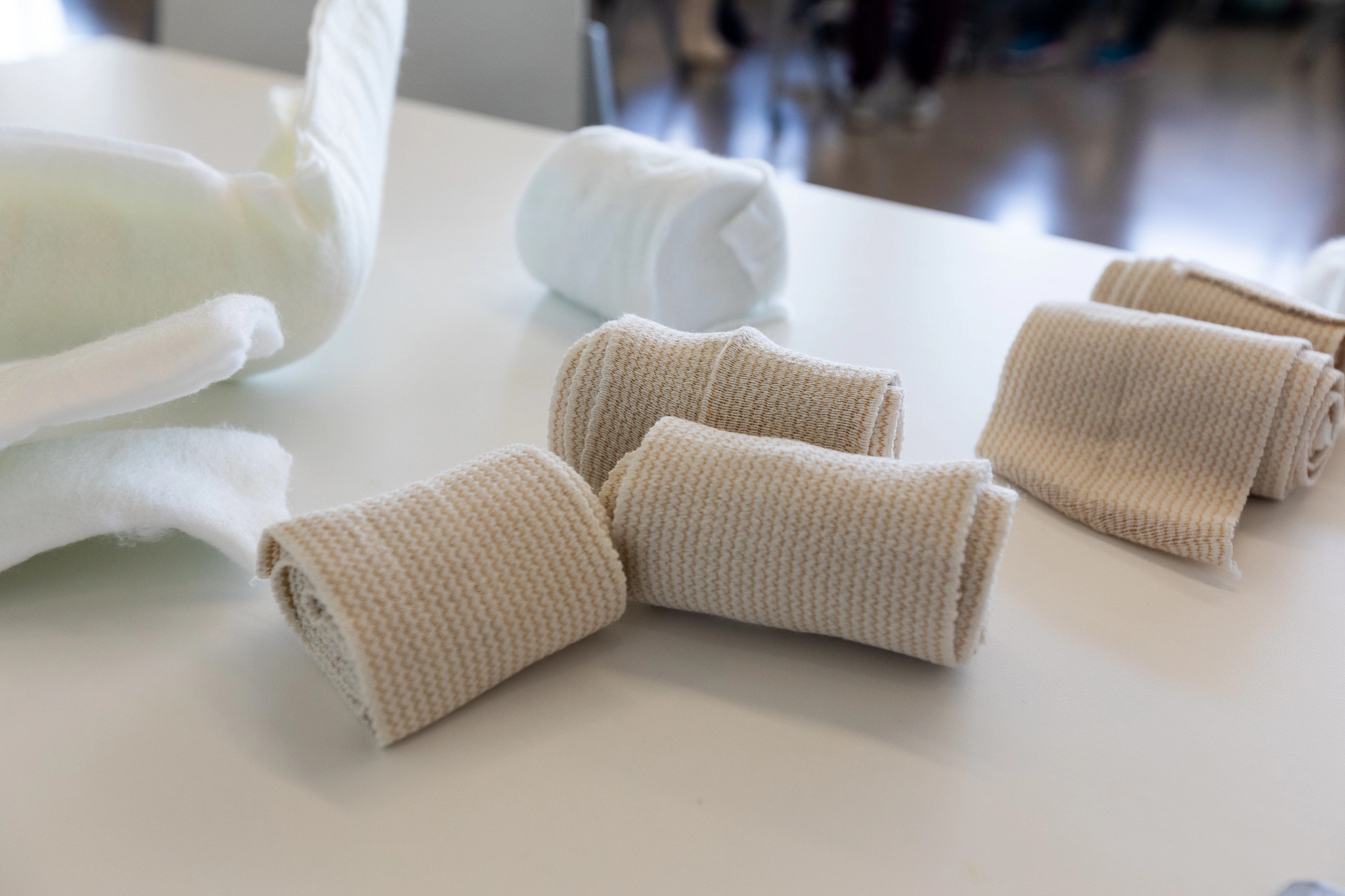 Rolls of bandages and gauze sitting on a table.