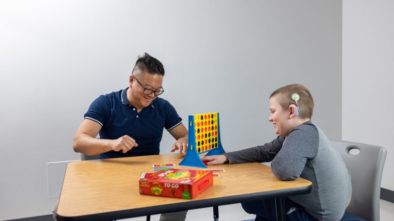 A student and a child playing a game.