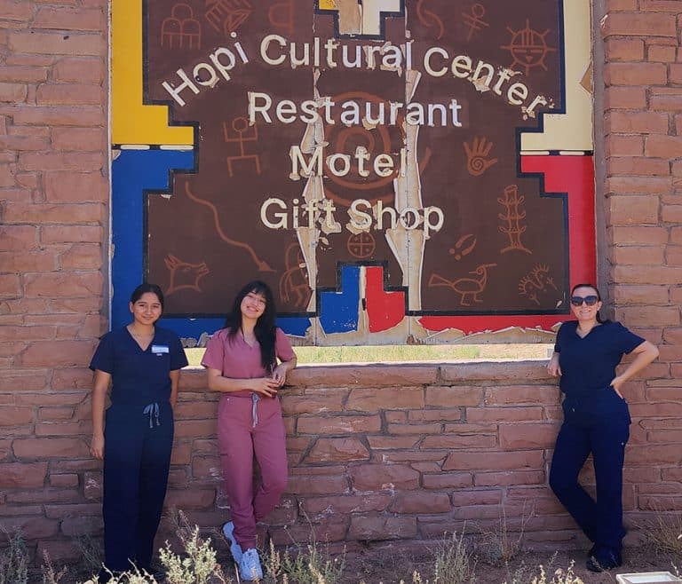 Students stand in front of the Hopi Cultural Center sign