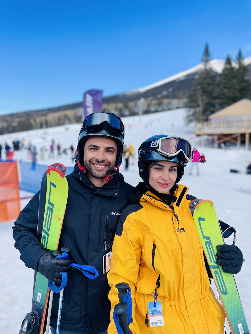 Sepideh (Sepi) Almasi posing while skiing with her partner.