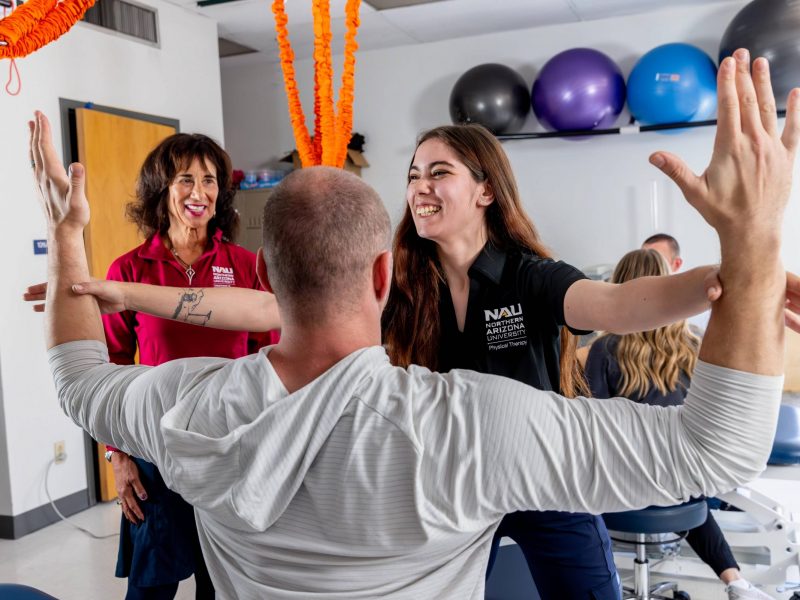N A U students practice technique in a Physical Therapy class.