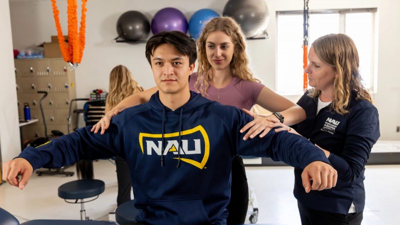 N A U students participate with the instructor in a physical therapy class.