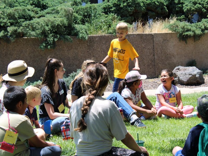 Camp Chit Chat, kids playing duck duck goose.