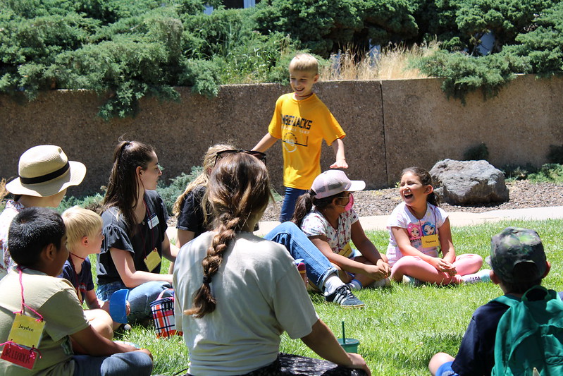 Camp Chit Chat, kids playing duck duck goose.