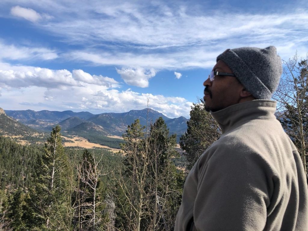 Dr. Michael Harris-Love, the 2024 winner from CHHS of the President's Alumni Award, overlooking Flagstaff mountains.