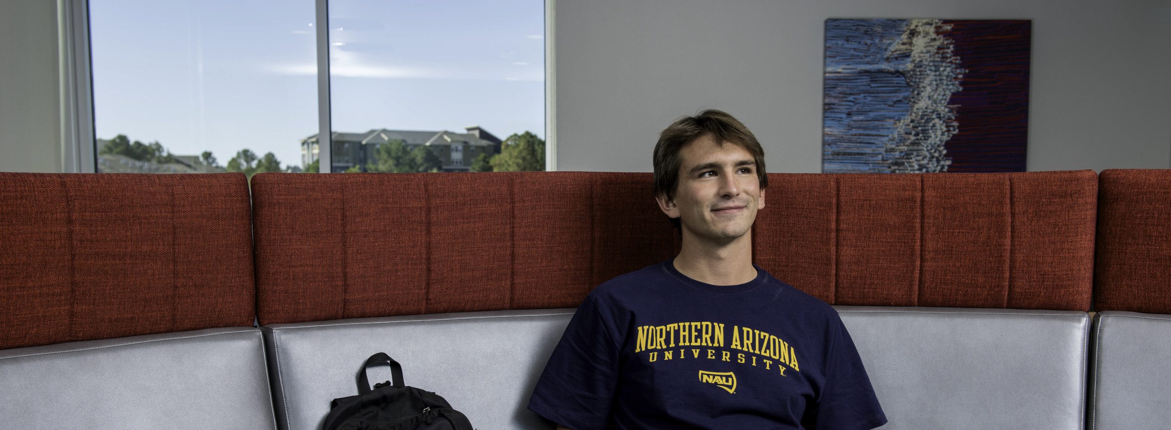 Student sitting in Honors Dorm at N A U.
