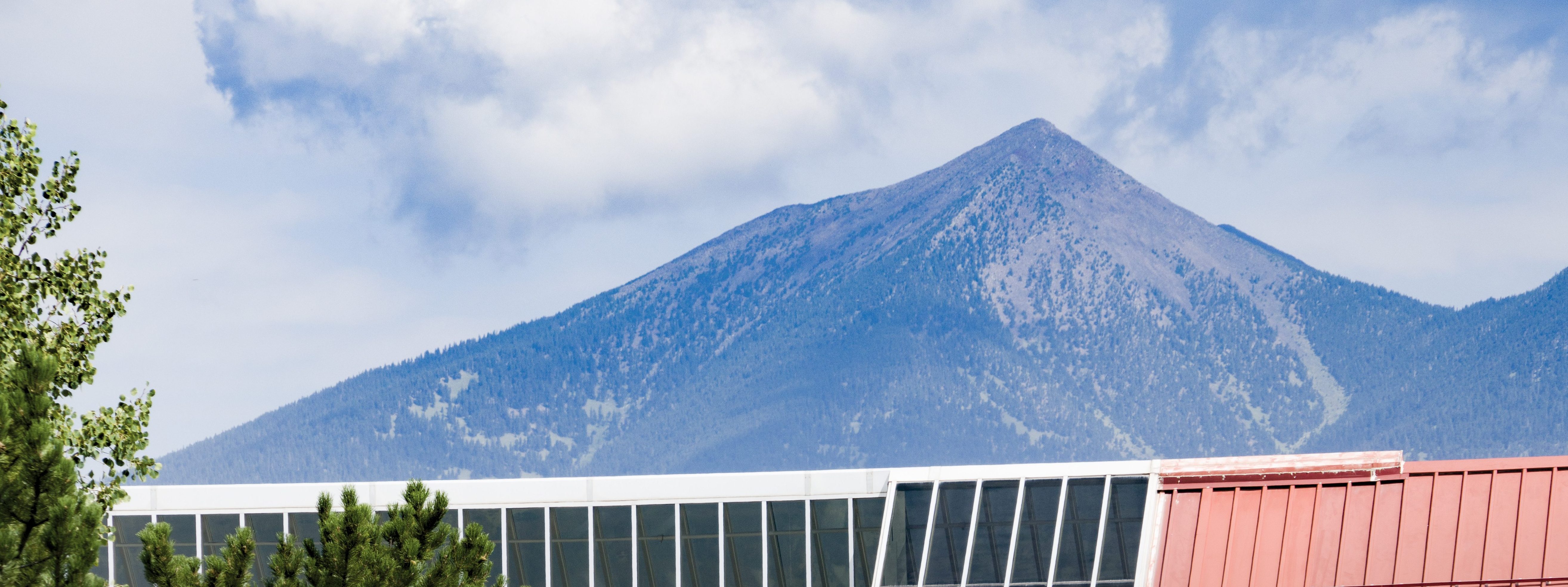 The San Francisco Peaks are seen over the Student Union.