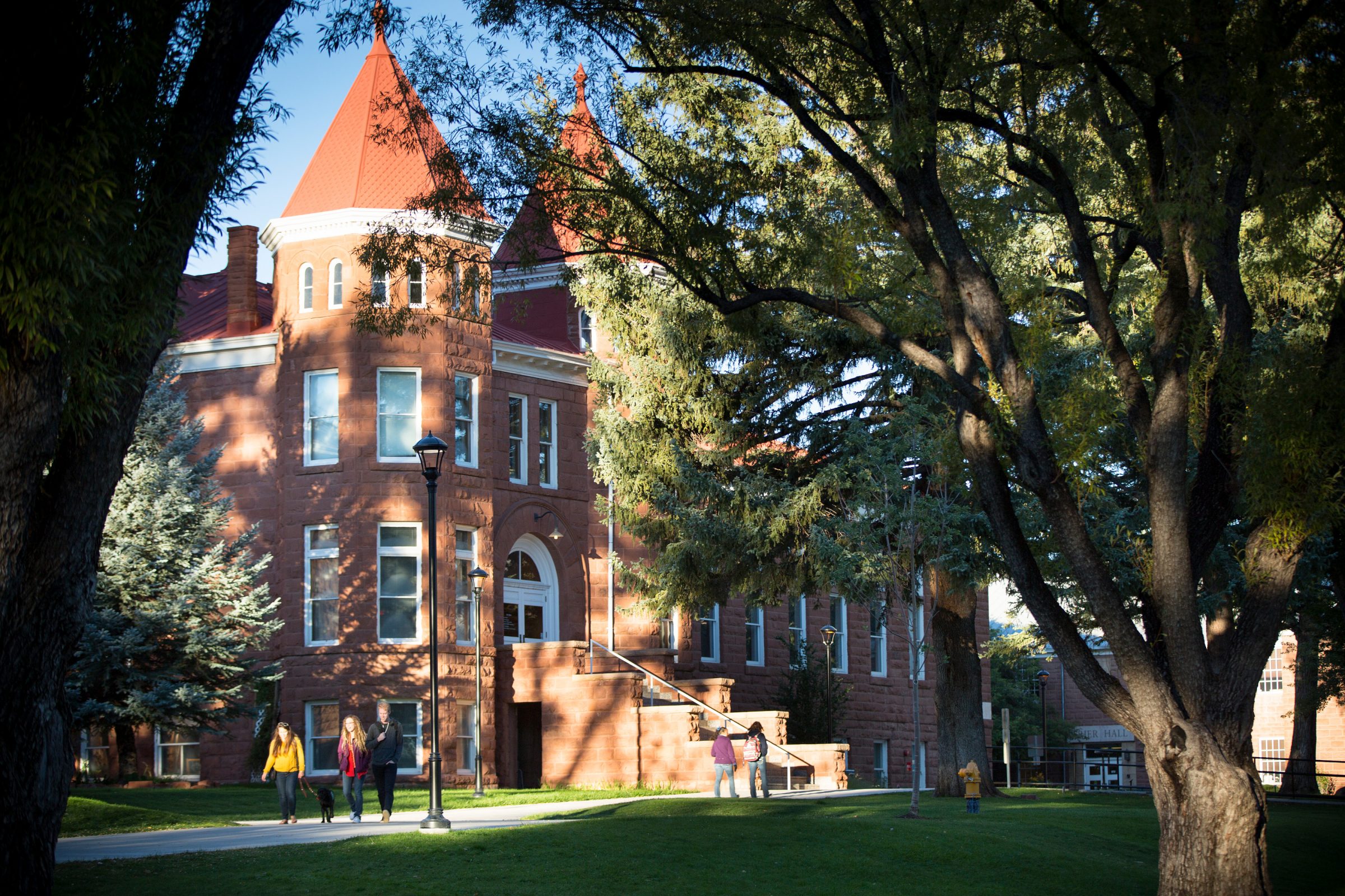 Students walk by the Old Main building on N A U Flagstaff campus.