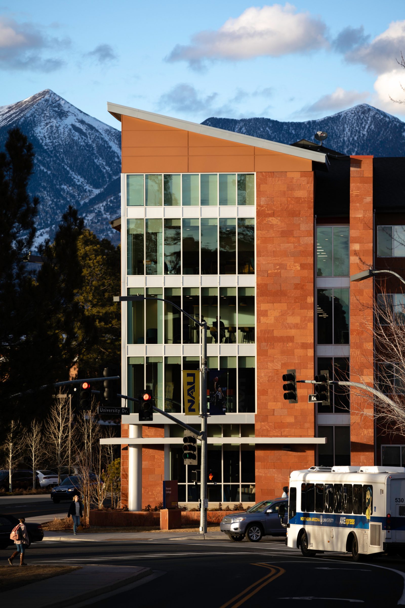 The Honors Collage building glows from the setting sun's light.