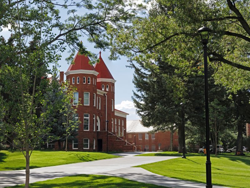 The Old Main building and surrounding lawn on a sunny, summer day.