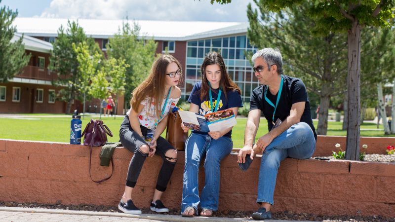 Potential N A U family looking over transfer brochure.