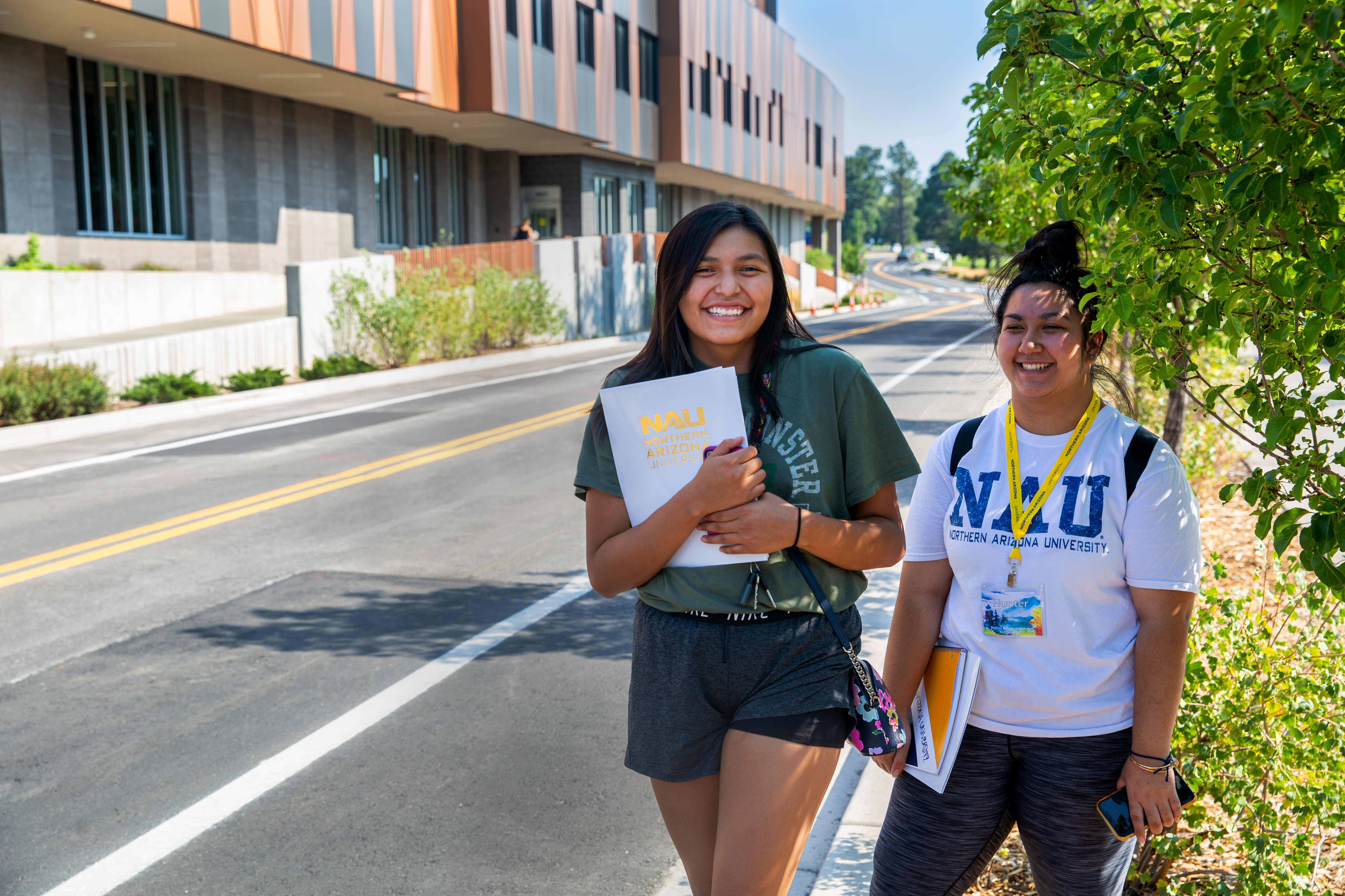 Students walk on sidewalk at NAU Flagstaff campus.