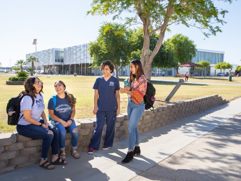 Students talking outside at the Yuma campus.