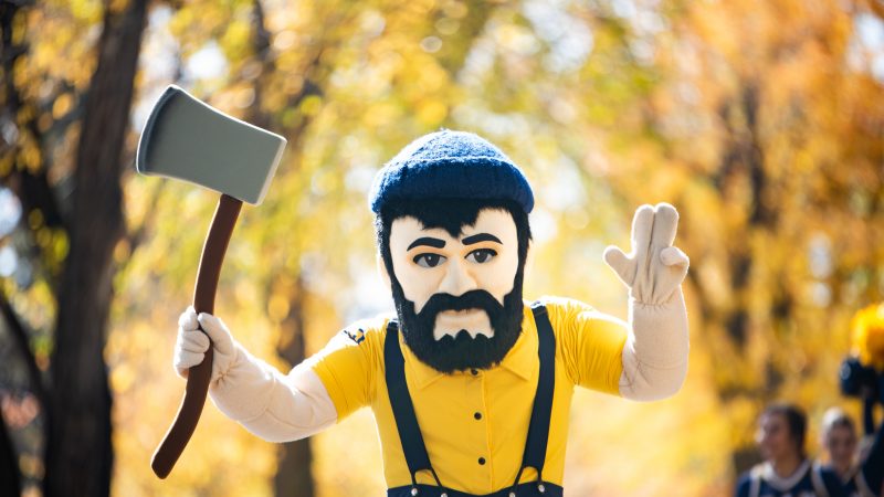 Louie the Lumberjack holding his axe and doing the "L J" hand symbol