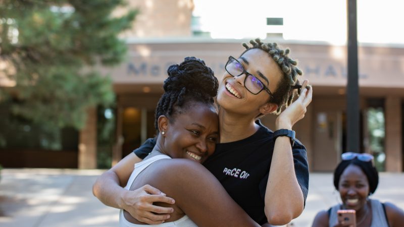 Students hugging each other.