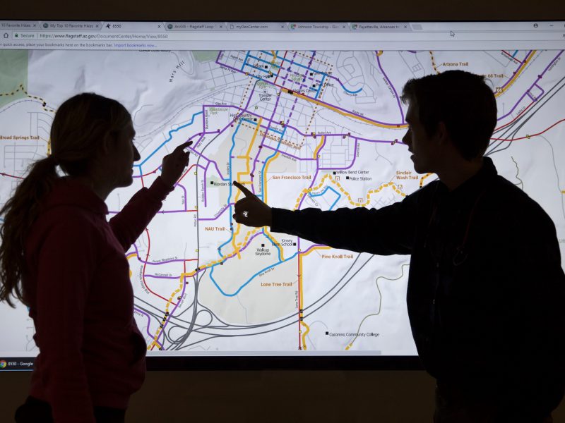 Students looking at a map on a screen.