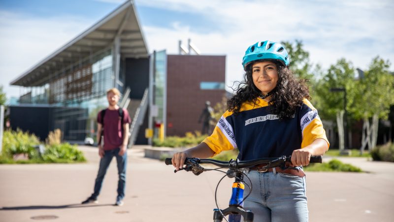 Student on her bike on campus.