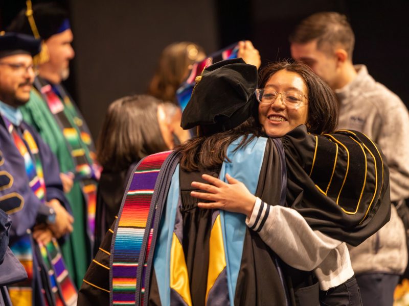 Two people hugging at the convocation.