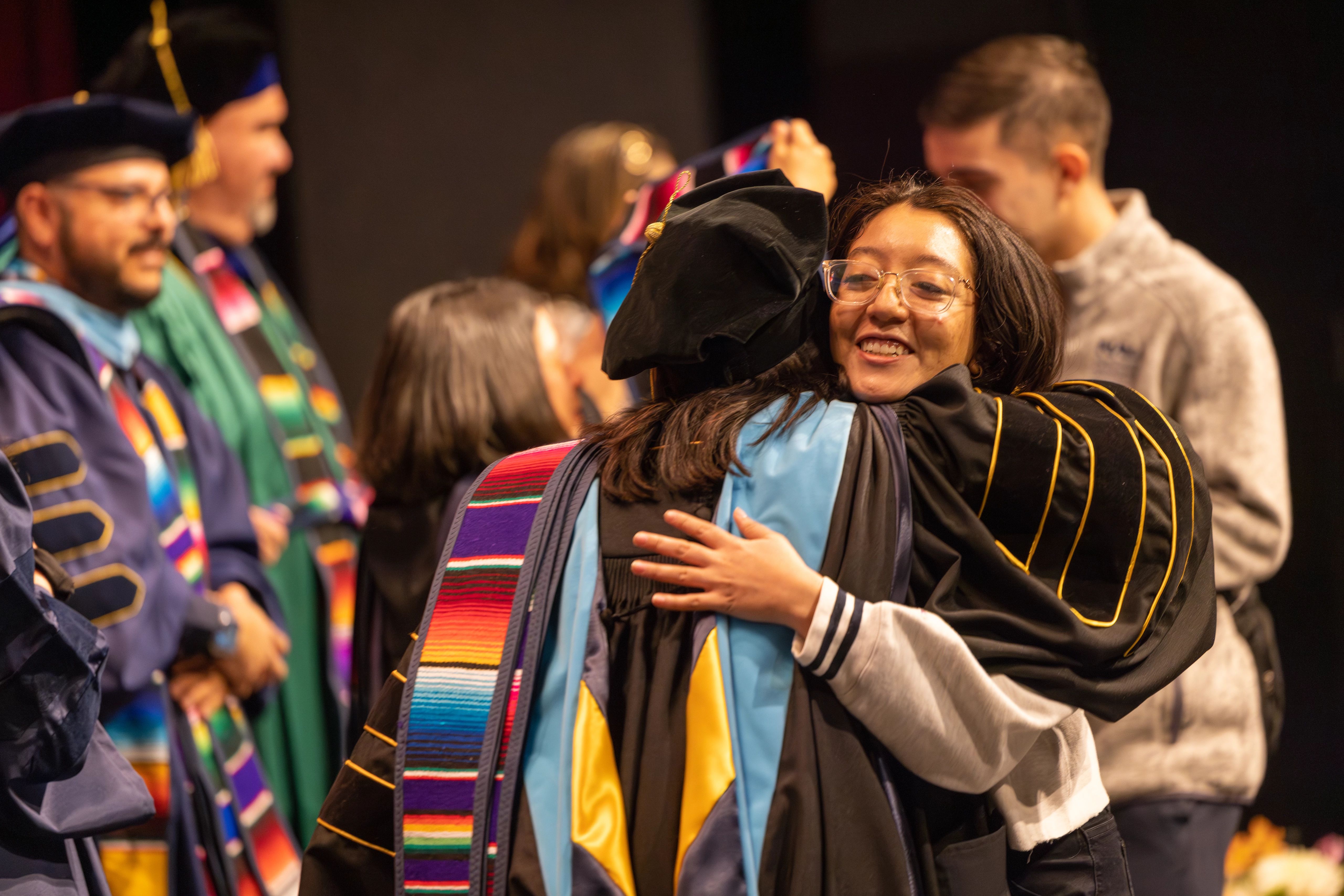 Two people hugging at the convocation.