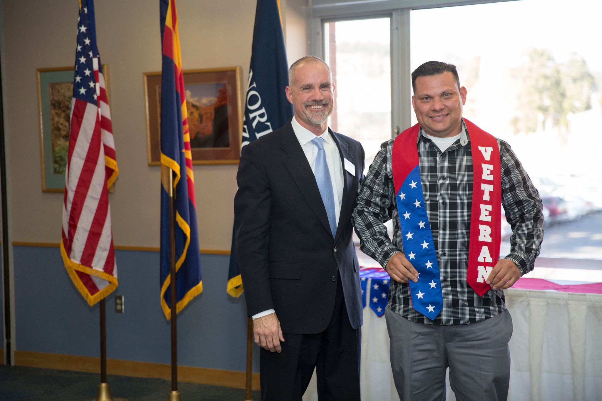 Two veterans are posing for the camera together at the Vet Convocation