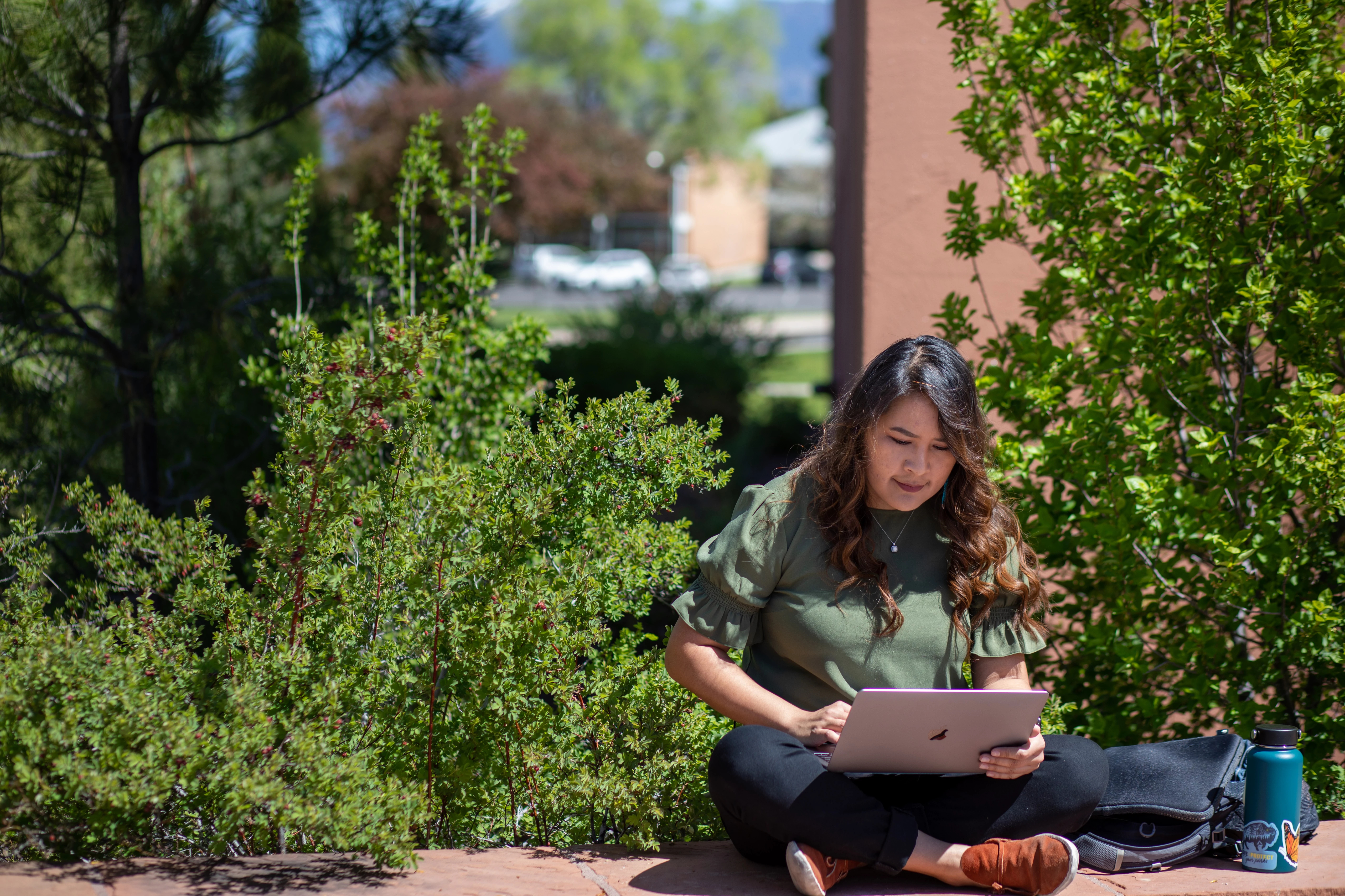Student working on a laptop computer outside.