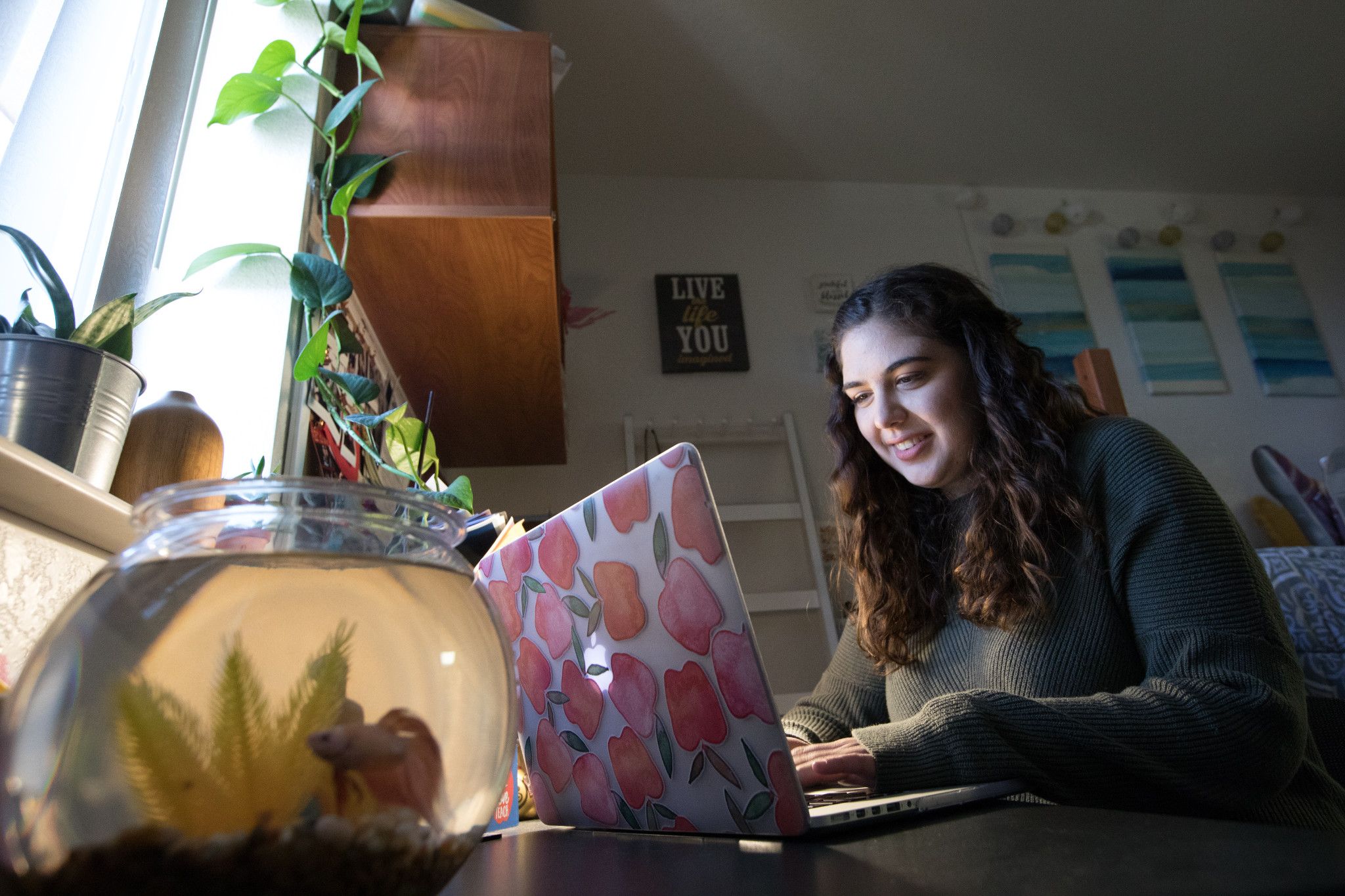 Student in residence hall on her computer