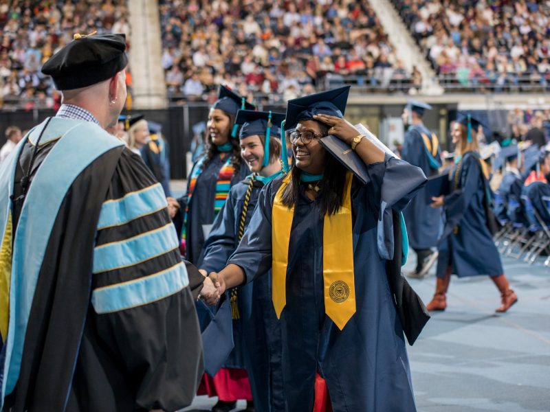 A Pacific Islander student at commencement at the N A U Flagstaff skydome.