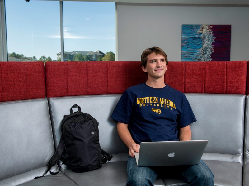 A student in the honors building on his computer.