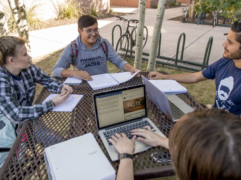 A photo of a group of students working outside.