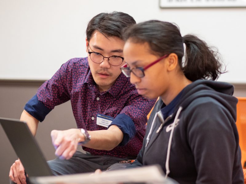 A photo of a student getting help from an advisor.