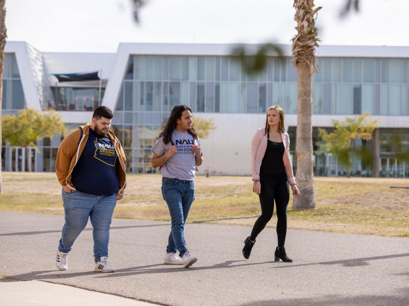 A photo of student walking on the Yuma campus.