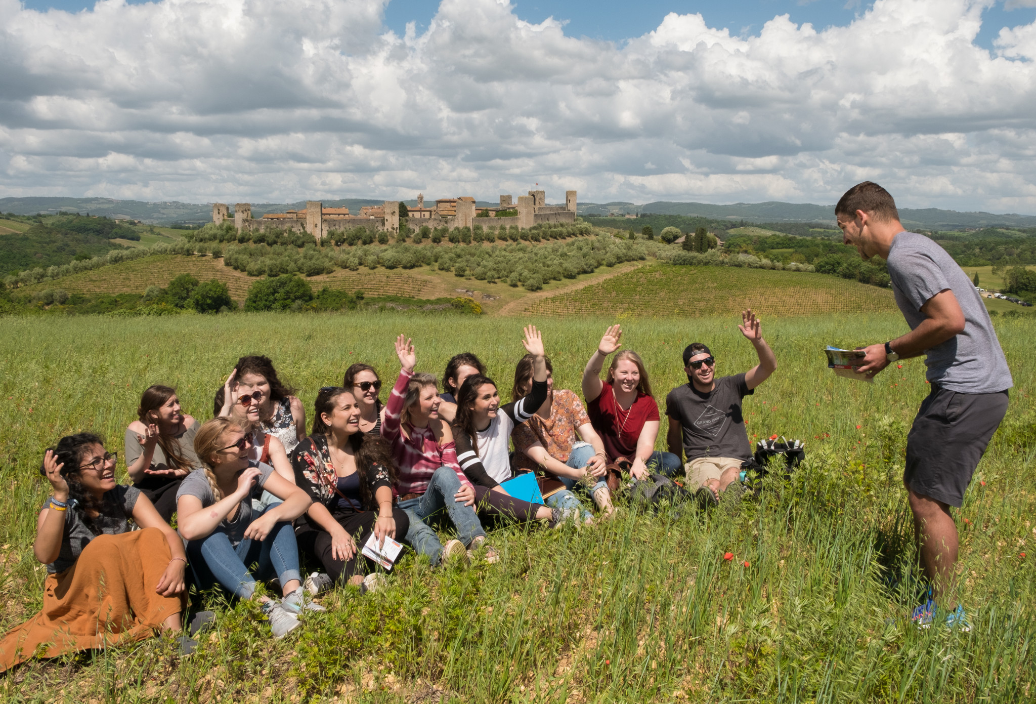 International education students sit in a field in Italy.