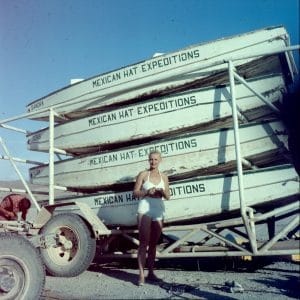 Katie Lee standing in front of a Mexican Hat Expeditions boat trailer