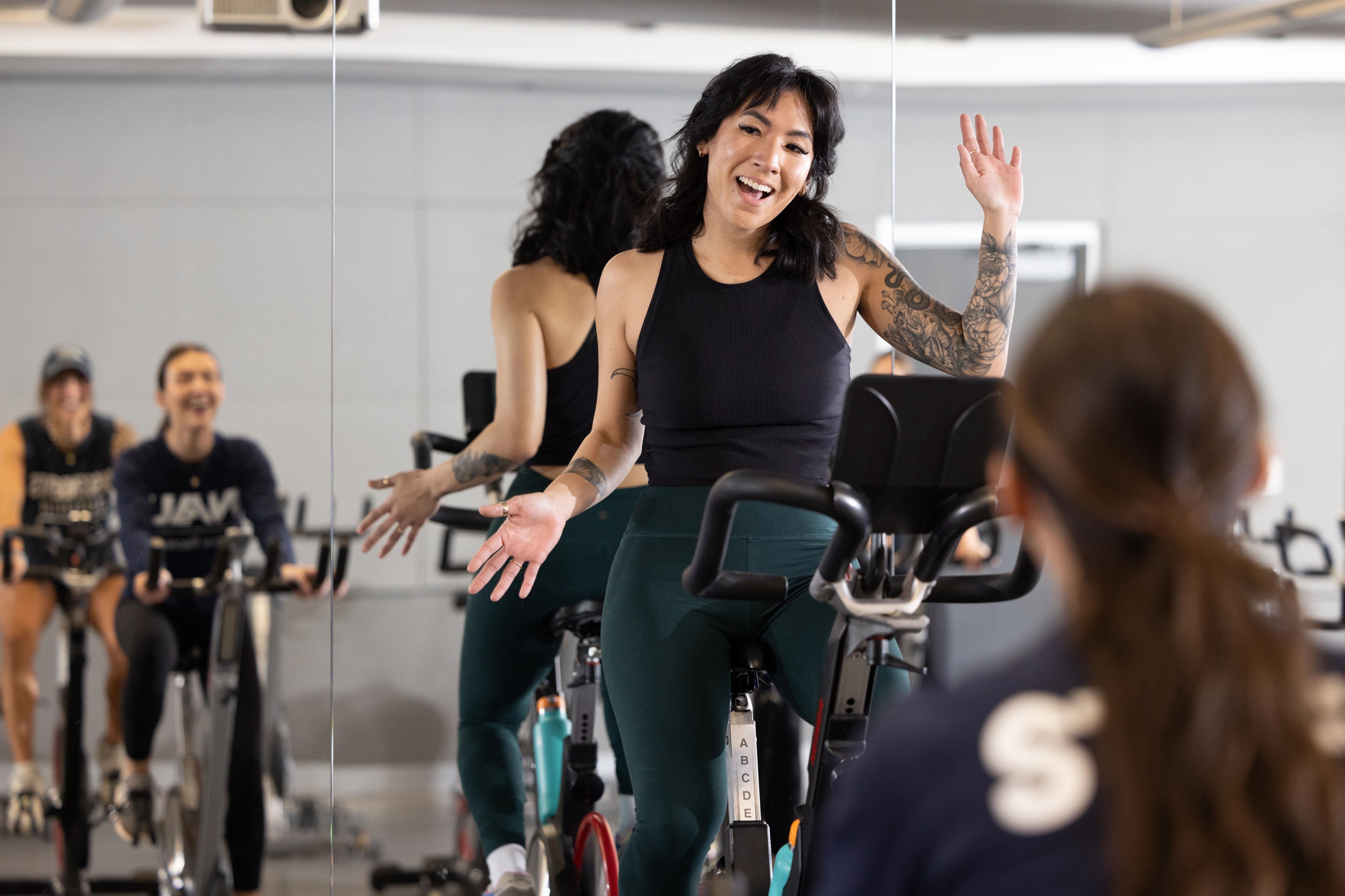 Spin class instructor holding a class.
