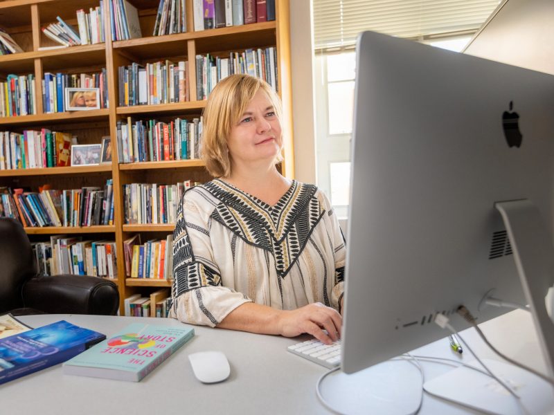 Faculty member working on a desktop computer