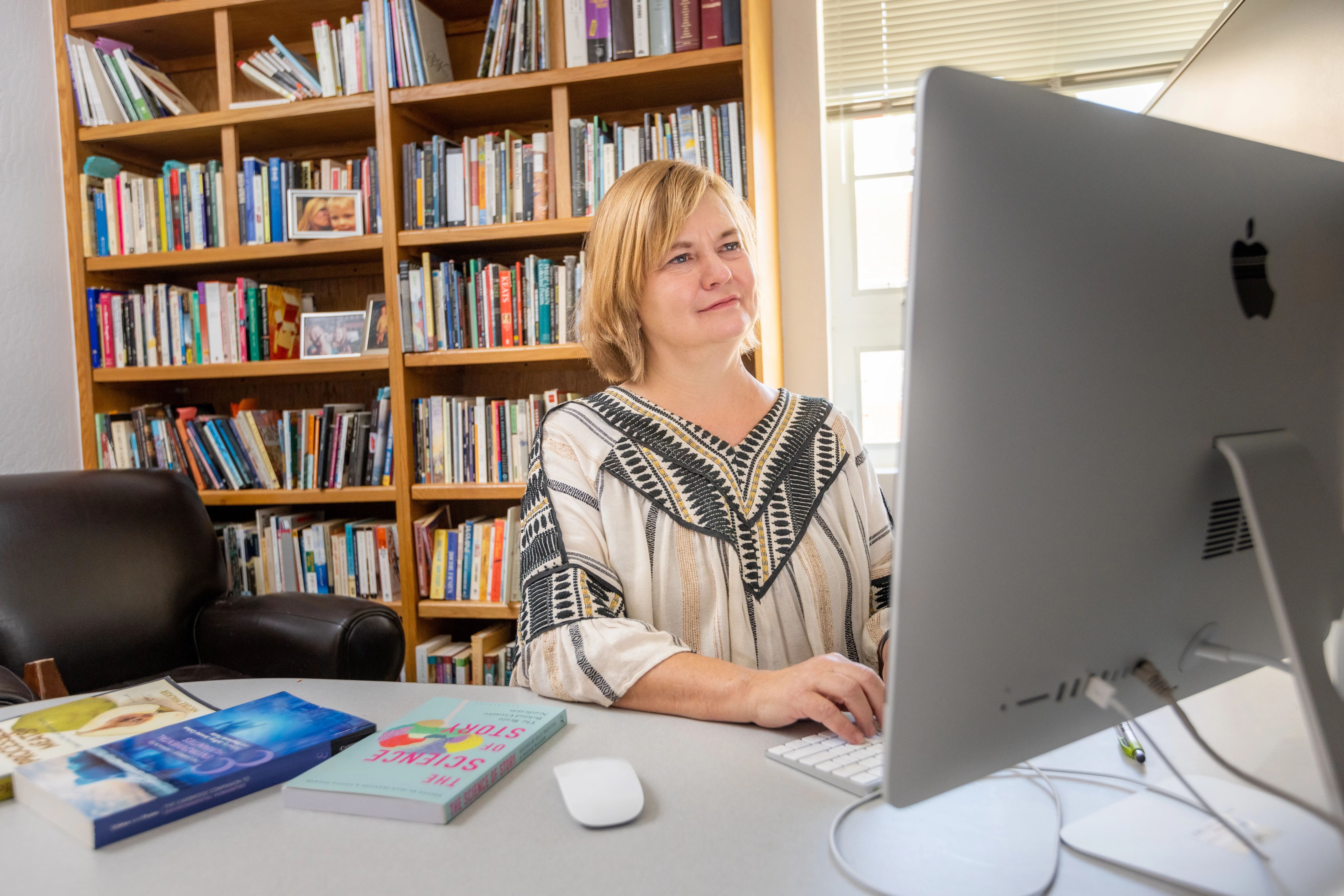 Faculty member working on a desktop computer