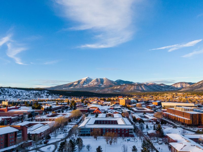 The San Francisco Peaks and the N A U Flagstaff campus glows during sunset.