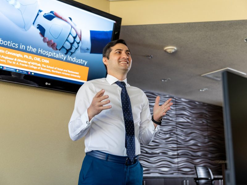 A man presenting in front of his presentation.