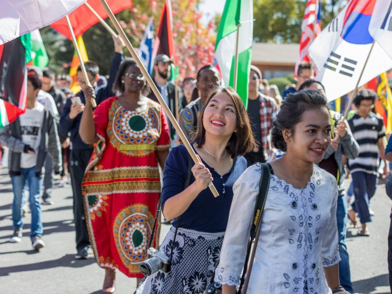 Students participating in the homecoming parade and celebrating different nationalities.