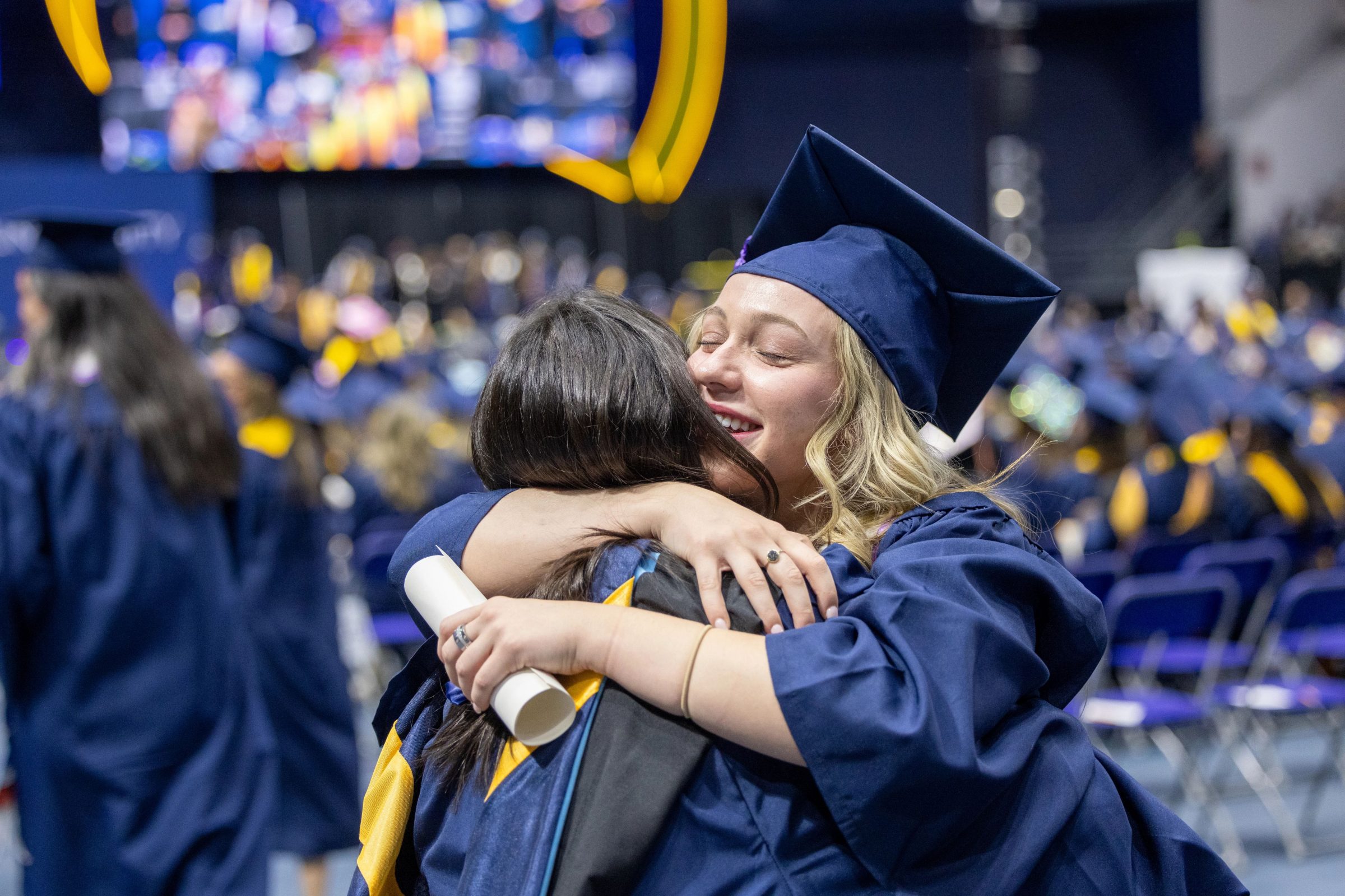 Students at commencement celebrating their graduation.