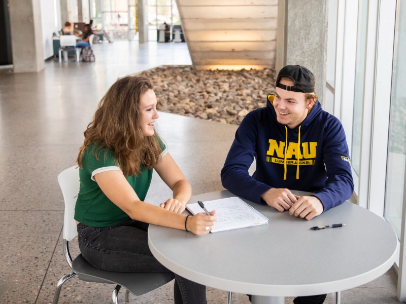 N A U students sit on campus and prepare for class.