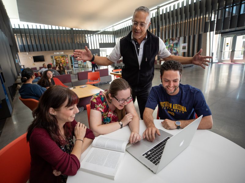 NAU students on a desk working together.