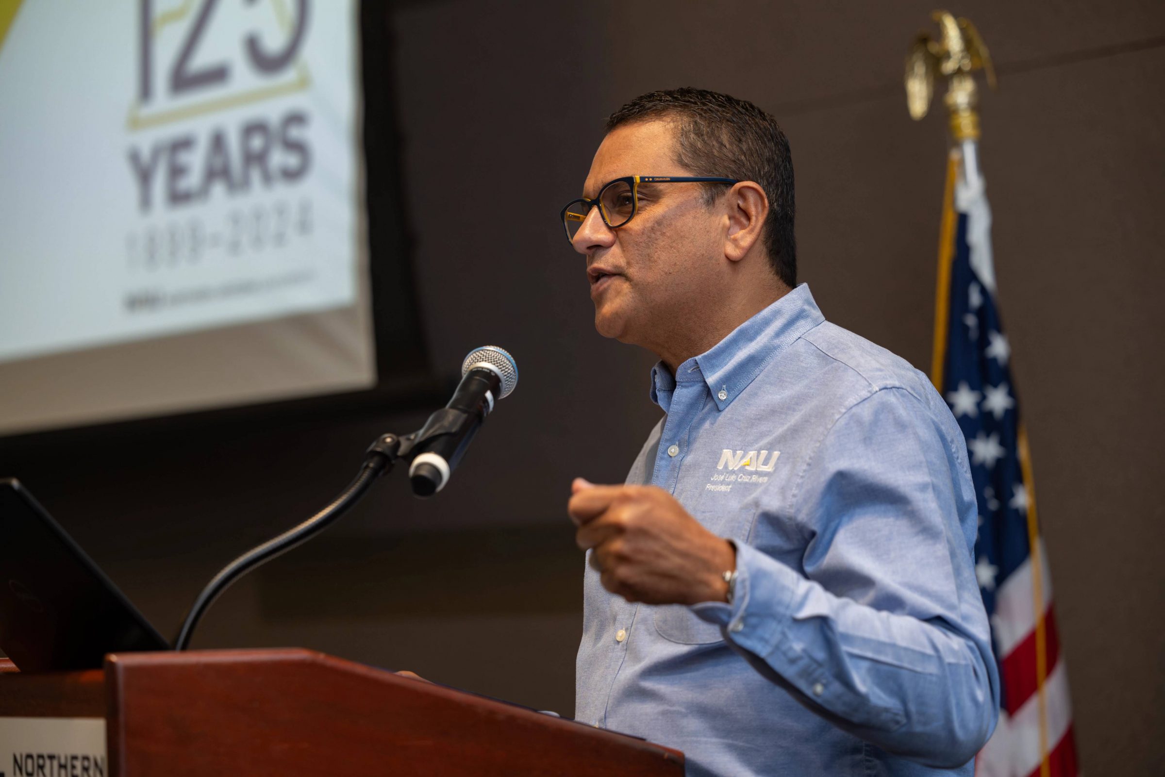 N A U President Cruz Rivera talking with university faculty and staff.