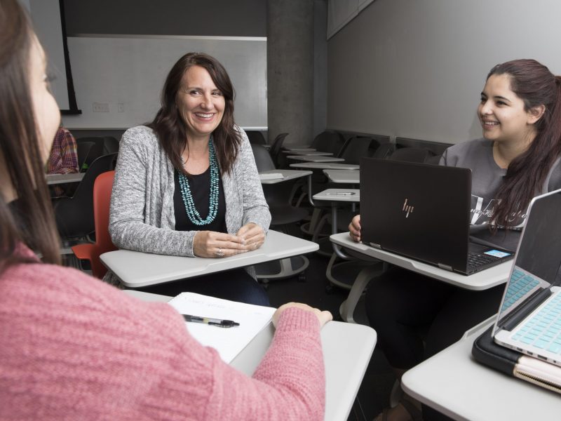 An N A U faculty member with a micro-certification works with their students.